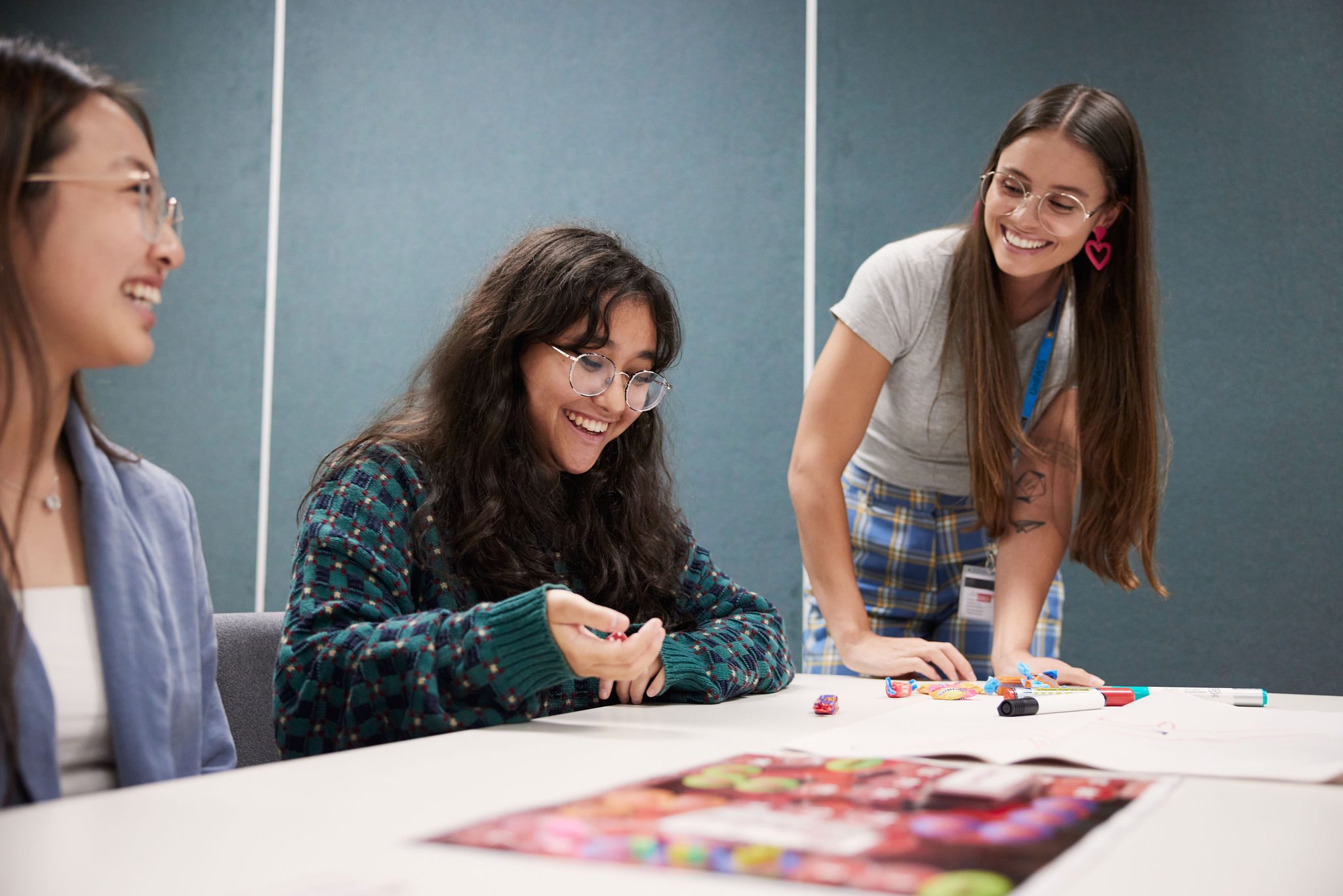 Students playing a game at a UniPASS session, with a Peer Learning Facilitator assisting.