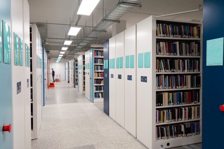 Image of the library compactus with books on the shelves.