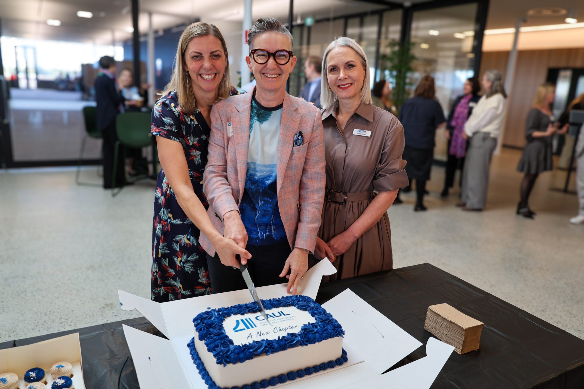  CAUL Board Director Michelle Blake (University Librarian, University of Waikato), CAUL Board Chair Nicole Clark (University Librarian, QUT) and CAUL CEO Jane Angel cutting the celebratory cake